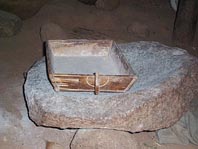 Sieve on grind stone